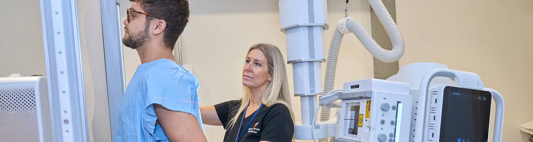 Medical technician positioning a patient for an imaging exam
