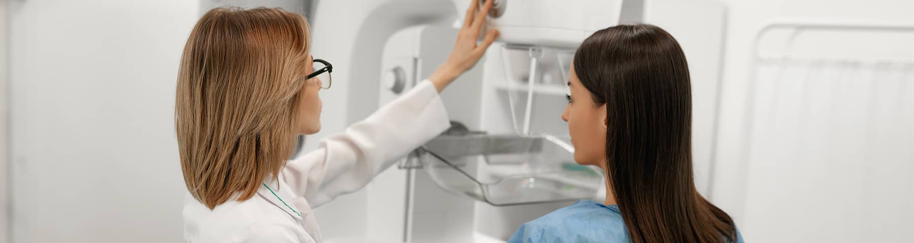 Technician preparing a patient for a mammogram